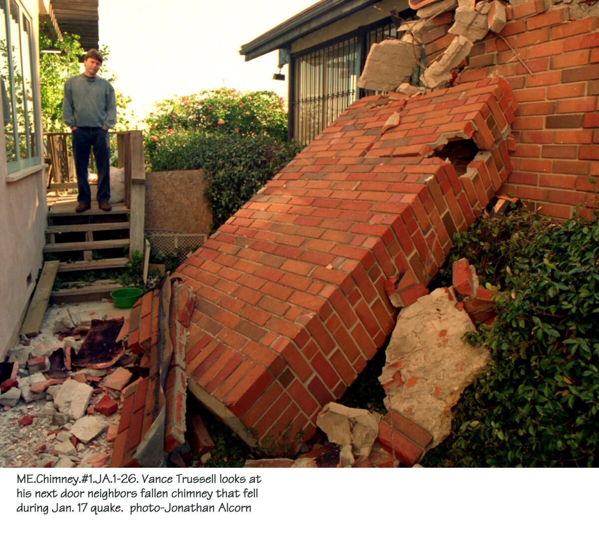 Vance Trussell looks at his next door neighbor's fallen chimney after the 1994 Northridge earthquake. (Jonathan Alcorn / Special to The Times)