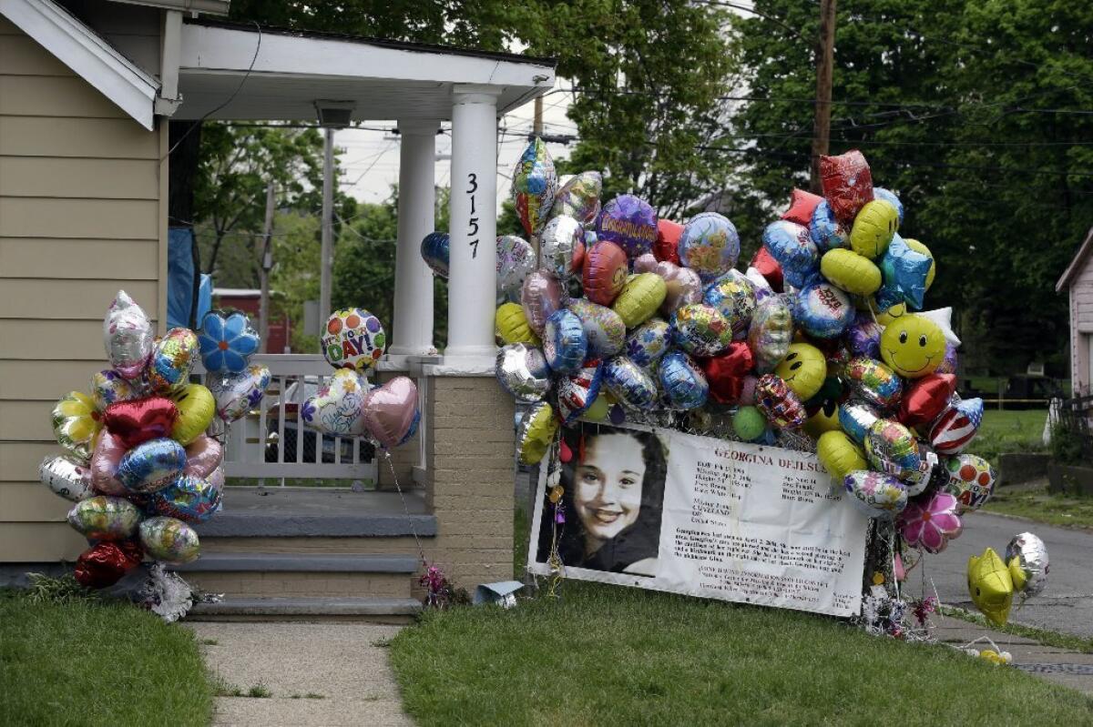 Balloons surround the porch at the home of Gina DeJesus in Cleveland on Friday. DeJesus was freed Monday from the home of Ariel Castro where she and two other women had been held captive for nearly a decade.