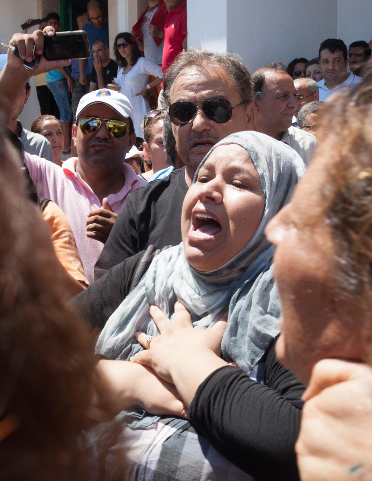 A Tunisian reacts outside Mahmoud Materi hospital Thursday following the death of opposition politician Mohammed Brahmi.