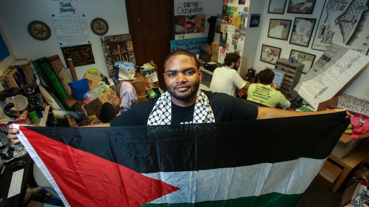 Robert Gardner, a senior at UCLA, stands in the Students for Justice in Palestine office.