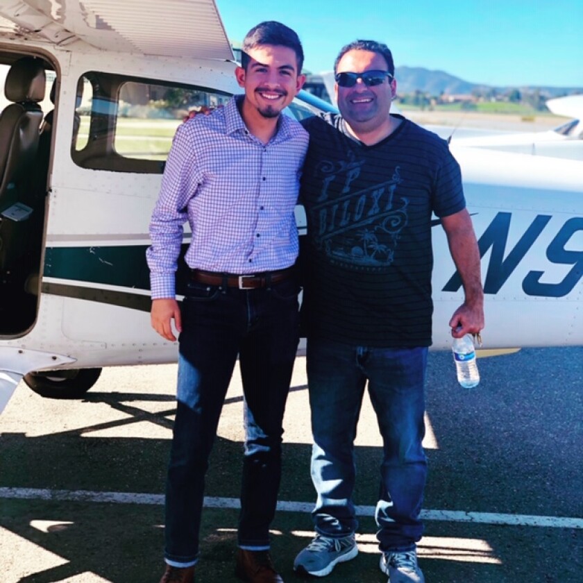 Reza Garajedaghi with a high school student who will start this summer as a commercial pilot.