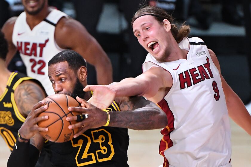 The Lakers' LeBron James grabs a rebound from Heat's Kelly Olynyk in Game 2 of the NBA Finals on Oct. 2, 2020.