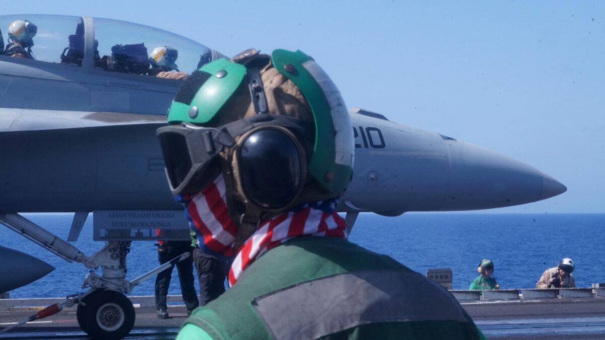 Navy sailors prepare to catapult launch a fighter jet from the deck of the USS Harry S. Truman aircraft carrier in the eastern Mediterranean.