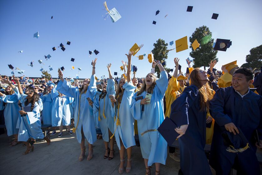 Graduates toss their caps in the air during the 2017 commencement ceremony for Marina High School on Thursday, June 15.