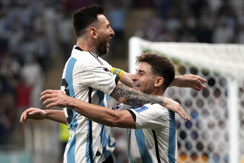 Argentina's Julian Alvarez, right, and Lionel Messi, left, celebrate their side's second goal during the World Cup round of 16 soccer match between Argentina and Australia at the Ahmad Bin Ali Stadium in Doha, Qatar, Saturday, Dec. 3, 2022. (AP Photo/Frank Augstein)