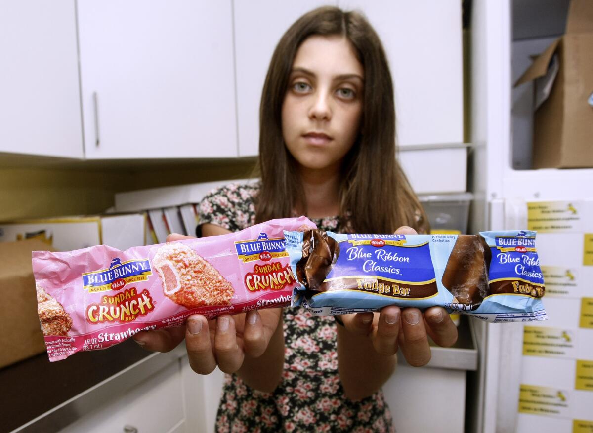 Luther Burbank Middle School 7th grader Ruby Gara shows the ice cream bars they have on hand to sell at the ASB student store in Burbank on Tuesday, Oct. 21, 2014. The ASB is allowed to sell snacks that do not compete with snacks sold at the cafeteria.