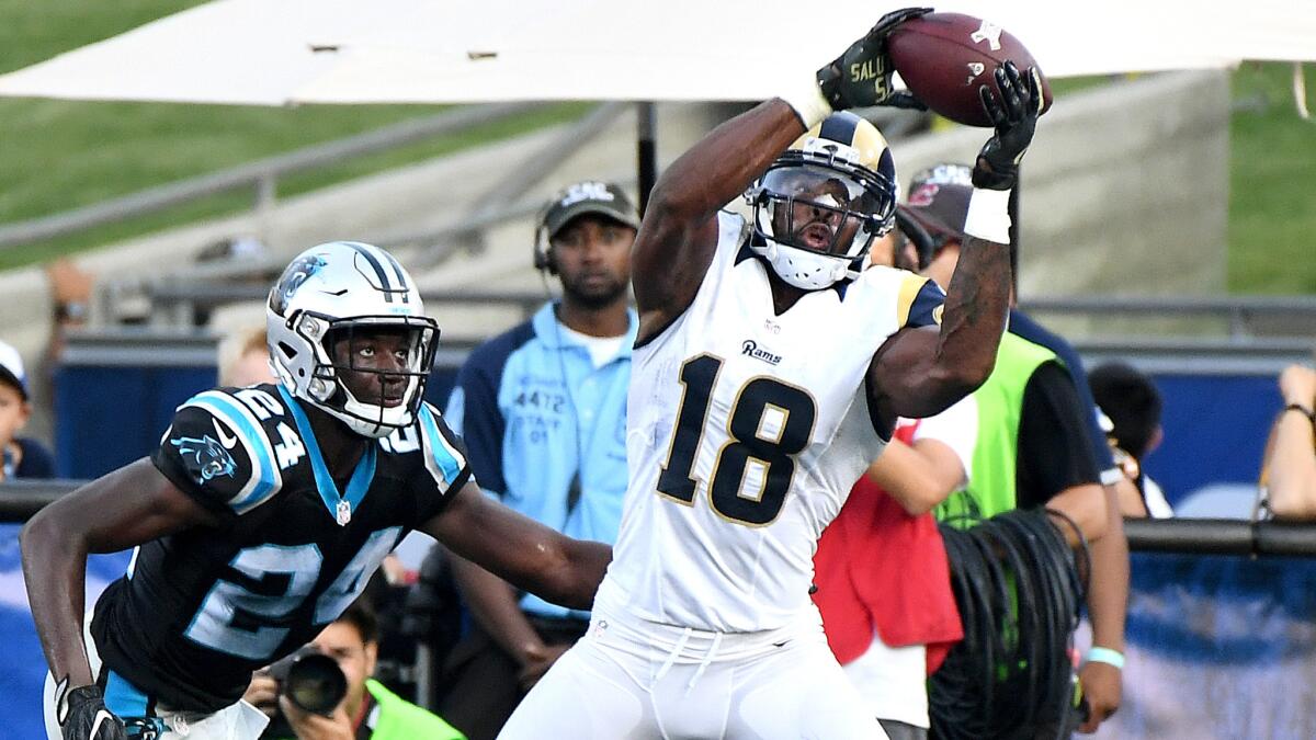 Rams receiver Kenny Britt catches a touchdown pass in front of Panthers defensive back James Bradberry late in the fourth quarter of a game Nov. 6 at the Coliseum.