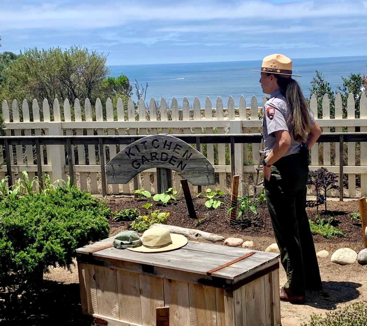 A park ranger stands in the replica kitchen garden at the 1855 Point Loma Lighthouse building at Cabrillo National Monument.
