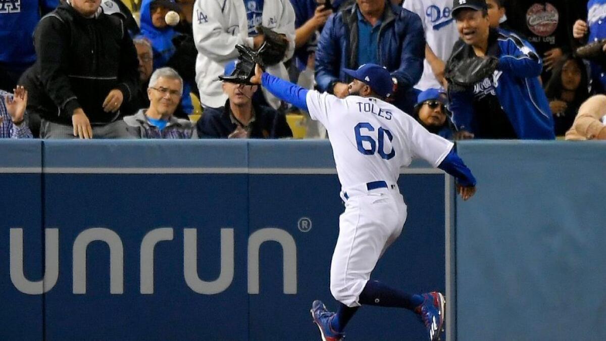 Los Angeles Dodgers' Andrew Toles (60) walks off the field after