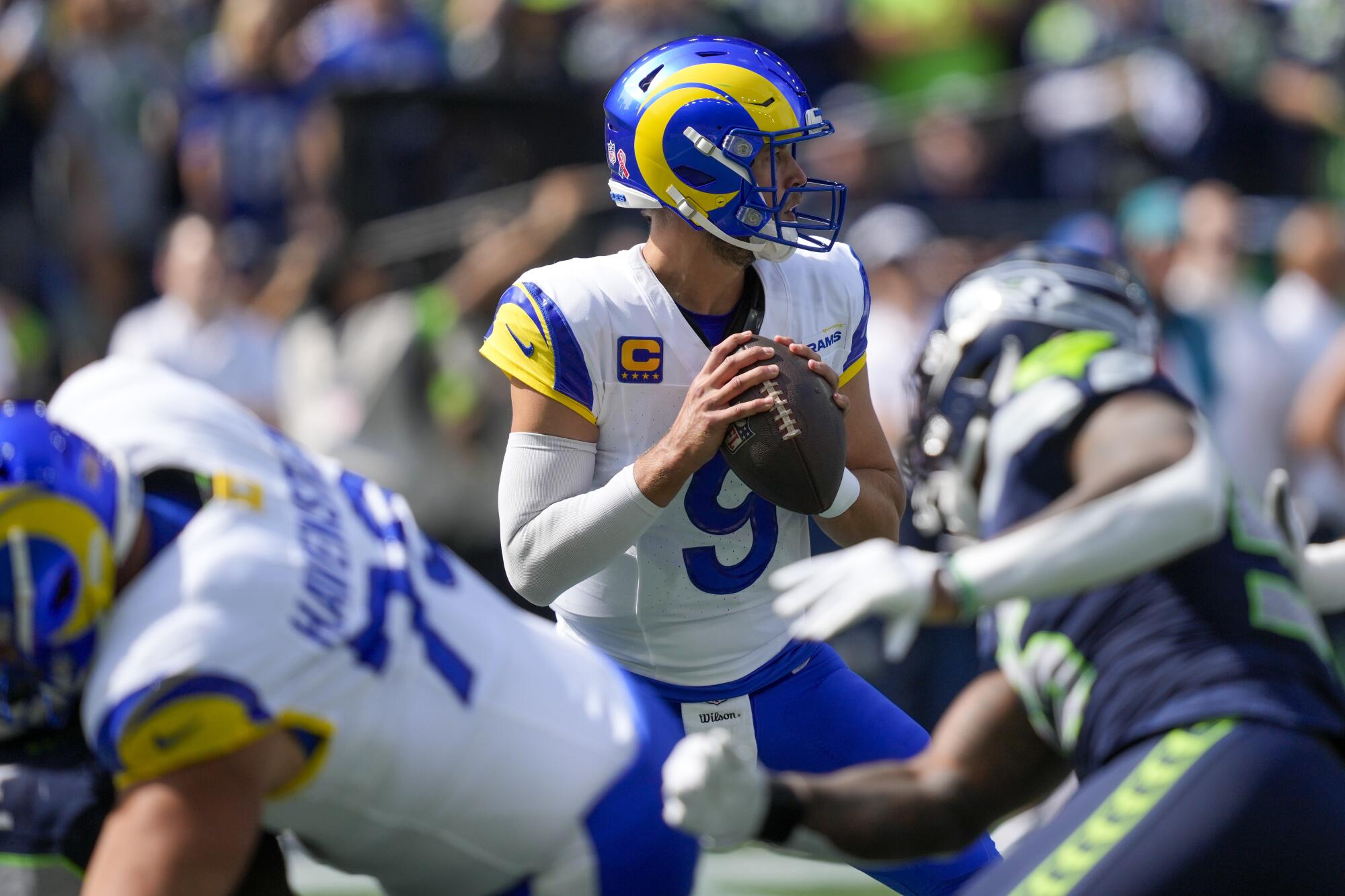 Los Angeles Rams quarterback Matthew Stafford looks to pass against the Los Angeles Rams.