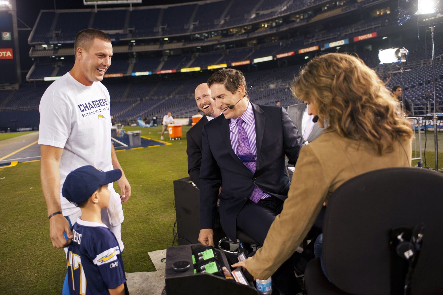 San Diego Chargers quarterback Philip Rivers and his son Gunner meet the ESPN crew of Trent Dilfer, Steve Young and Suzy Kolber after a Monday Night Football game against the Indianapolis Colts at Qualcomm Stadium. The Chargers won 19-9 on Oct. 14, 2011.