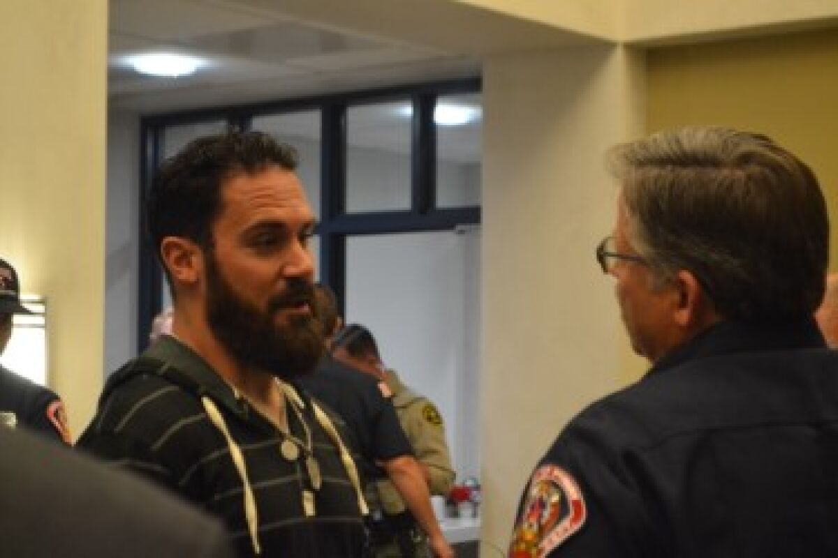Super Bowl champion Eric Weddle speaks with Poway Fire Chief Jeff Chumbley.