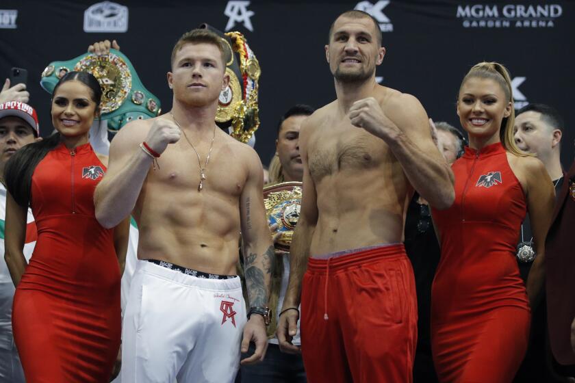 Canelo Alvarez, center left, and Sergey Kovalev pose for photographers during a weigh-in Friday, Nov. 1, 2019, in Las Vegas. The two are scheduled to fight in a WBO light heavyweight title bout Saturday in Las Vegas. (AP Photo/John Locher)