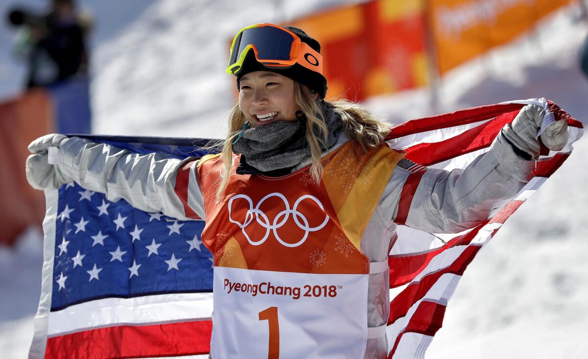 Chloe Kim celebrates after winning gold in halfpipe snowboarding at the 2018 Winter Olympics in South Korea.