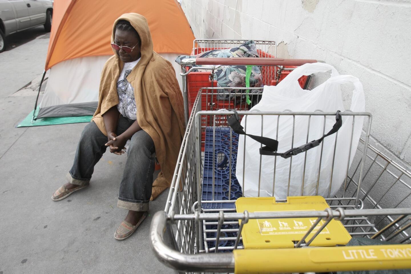 Annie Moody sits next to her tent on Towne Avenue at 6th Street on in the skid row area of Los Angeles.
