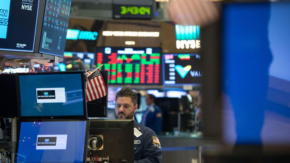 Fewer than 14% of American households directly own stock in any company. Above, a trader on the floor of the New York Stock Exchange.