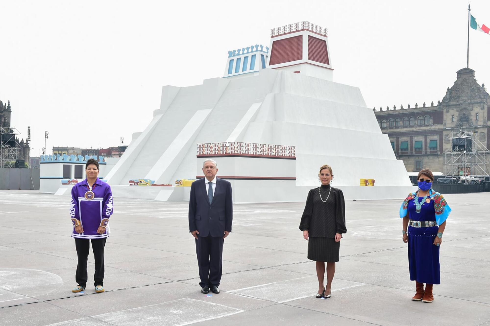 President Andrés Manuel López Obrador and dignitaries stand in front of a replica of the Templo Mayor in Mexico City.