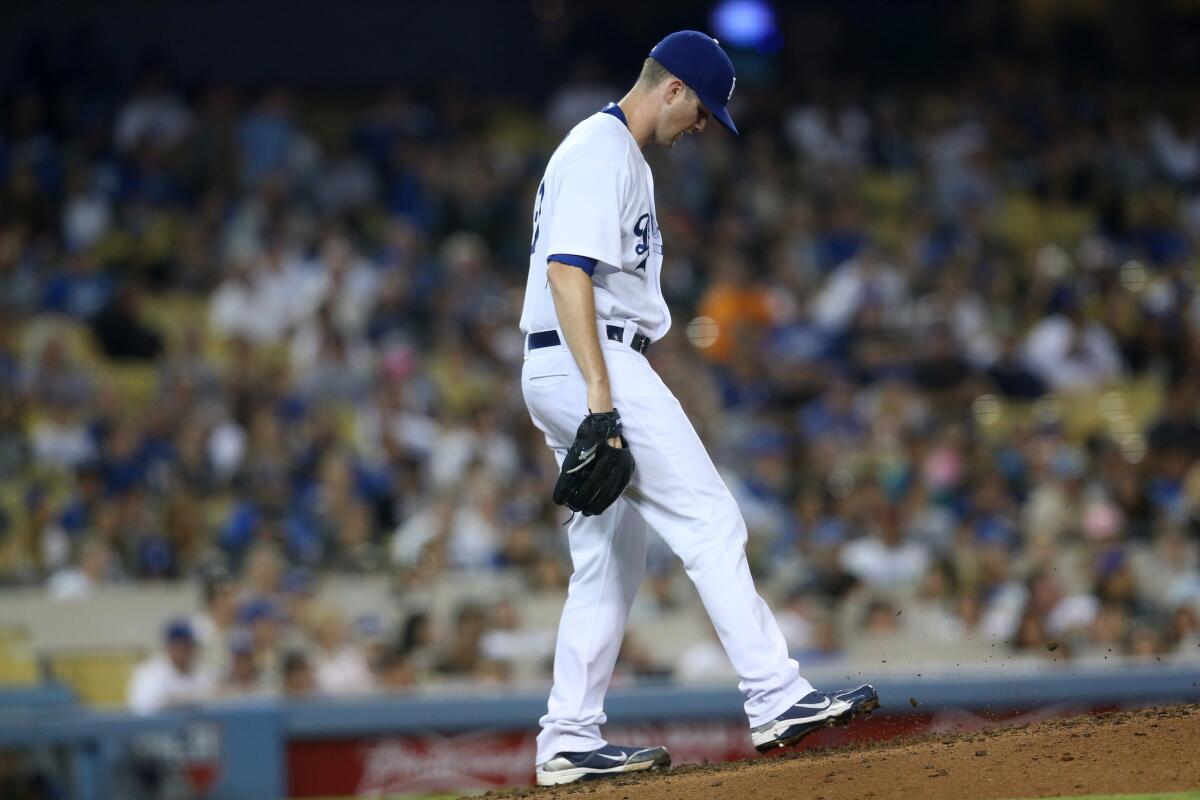 Dodgers pitcher Alex Wood reacts after giving up a home run to the Diamondbacks' A.J. Pollock at Dodger Stadium on Sept. 22.