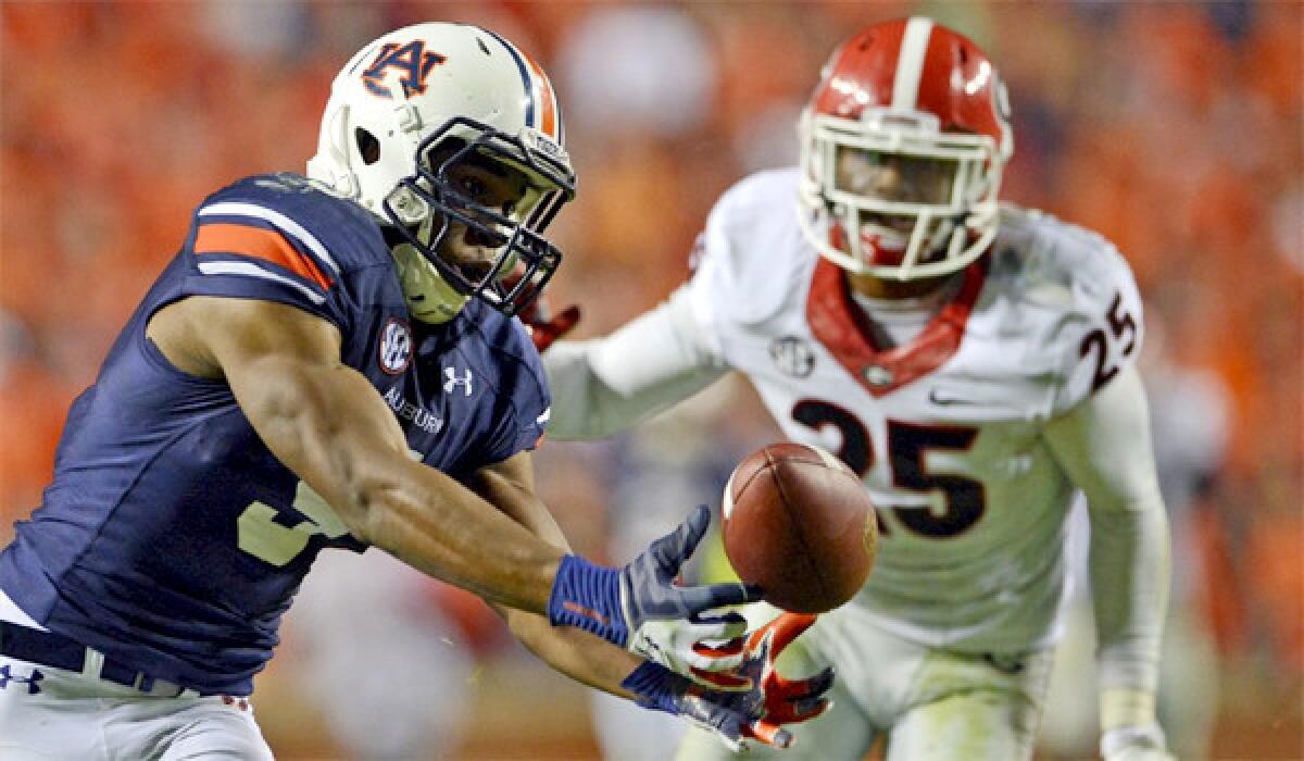 Auburn receiver Ricardo Louis makes an improbable catch against Georgia after Bulldogs defenders failed to corral an underthrown pass and it fell into Louis' waiting hands for a 73-yard game-winning touchdown.