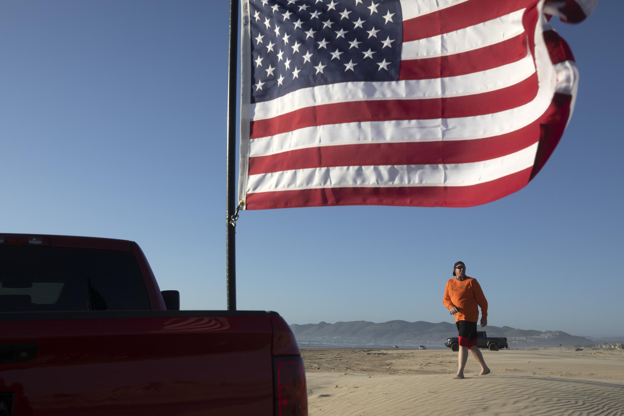 An American flag with a person in the background