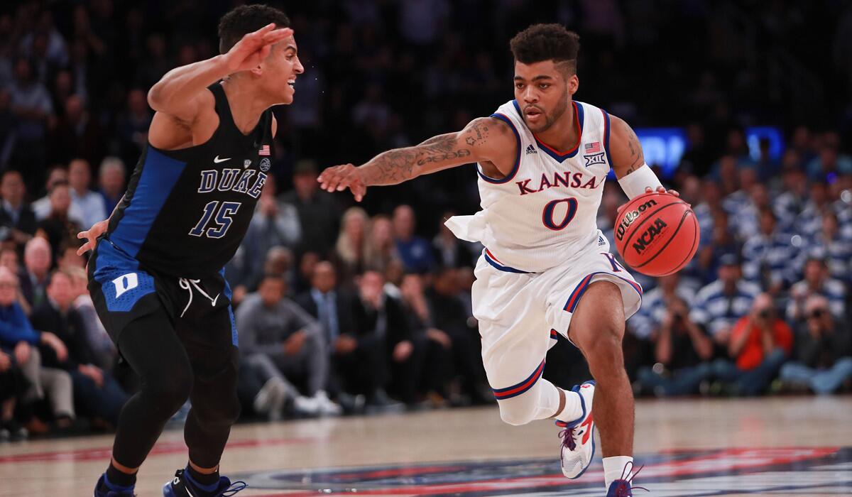 Kansas' Frank Mason III, right, drives to the basket against Duke's Frank Jackson in the second half during the State Farm Champions Classic at Madison Square Garden on Tuesday.