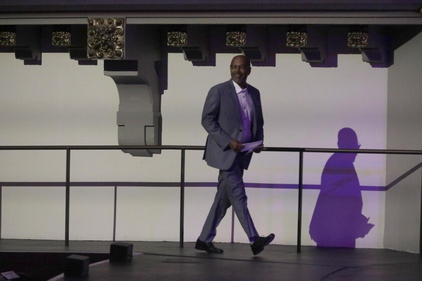 A man walks across a stage.