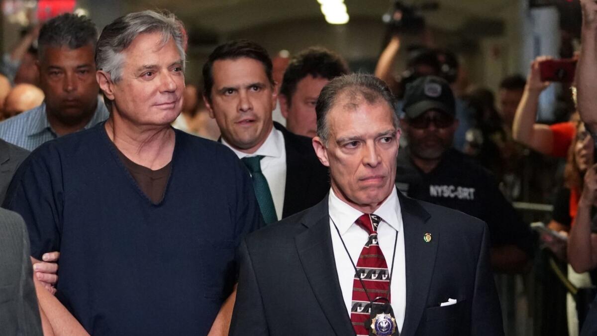 Paul Manafort, left, President Trump's onetime campaign chairman, arrives at Manhattan Supreme Court on Thursday.