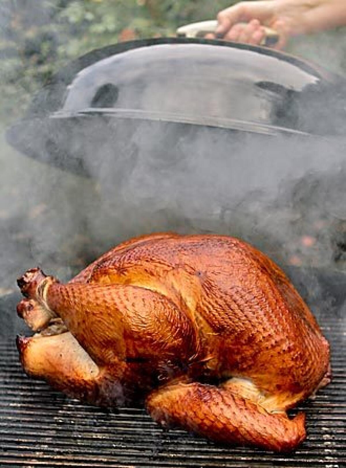 A turkey is grilled using hickory chips. It frees up the oven.