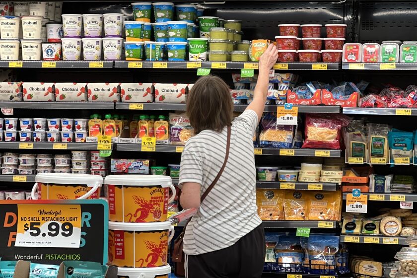 A customer looks at refrigerated items at a Grocery Outlet store in Pleasanton, Calif.,. on Thursday, Sept. 15, 2022. "Best before” labels are coming under scrutiny as concerns about food waste grow around the world. Manufacturers have used the labels for decades to estimate peak freshness. But “best before” labels have nothing to do with safety, and some worry they encourage consumers to throw away food that’s perfectly fine to eat. (AP Photo/Terry Chea)