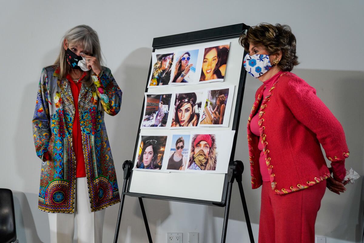 Janet Baggett wipes her eyes as she and her attorney stand next to a board with pictures of her daughter Elizabeth Baggett.
