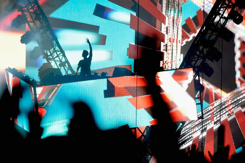 DJ Calvin Harris performs Sunday night at the Coachella Valley Music and Arts Festival in Indio.