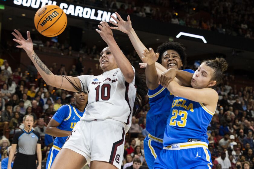 South Carolina's Kamilla Cardoso (10) fights for a rebound over UCLA's Gabriela Jaquez (23) and Christeen Iwuala, center, in the first half of a Sweet 16 college basketball game at the NCAA Tournament in Greenville, S.C., Saturday, March 25, 2023. (AP Photo/Mic Smith)