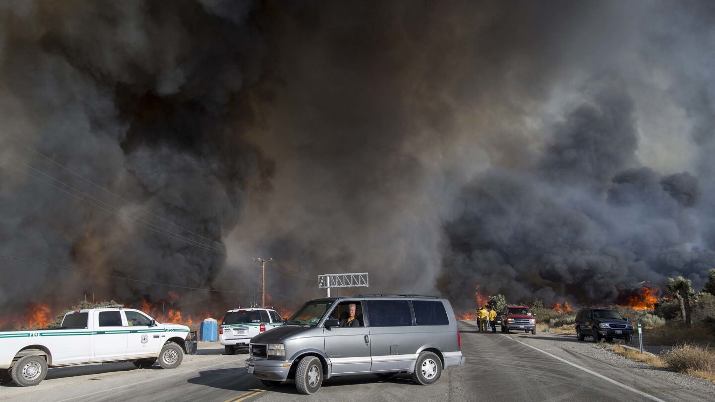 Motorists flee The Blue Cut fire as it burns out of control on both sides of Highway 138 in Summit Valley.