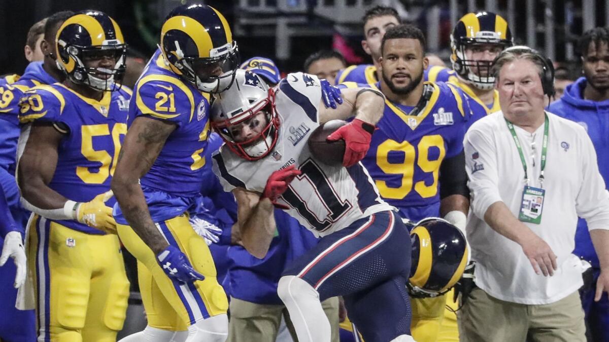 Patriots receiver Julian Edelman is brought down by Rams cornerback Aqib Talib after a reception during the first half.