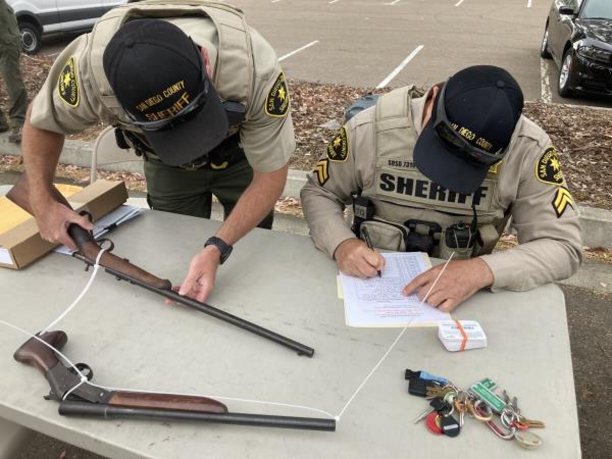 Sheriff's deputies collected firearms during a trade-in event in Encinitas on Sunday.