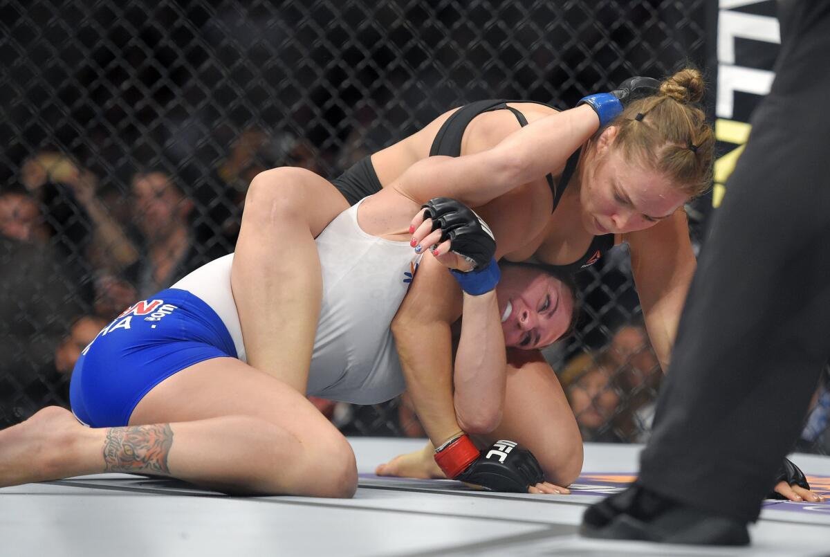 Ronda Rousey, top, quickly turned the tables after a quick charge by Cat Zingano on Saturday night.
