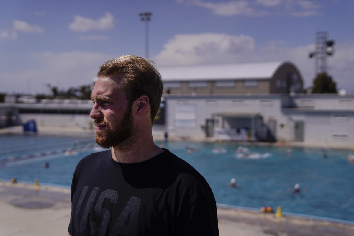 \Water polo player Marko Vavic pauses for photos at MWR Aquatic Training Center in Los Alamitos, Calif., Tuesday, April 27, 2021. Two years after his father, Jovan, was arrested as part of a college admissions investigation dubbed Operation Varsity Blues, Vavic is pushing for a spot on the U.S. men's Olympic water polo team. (AP Photo/Jae C. Hong)