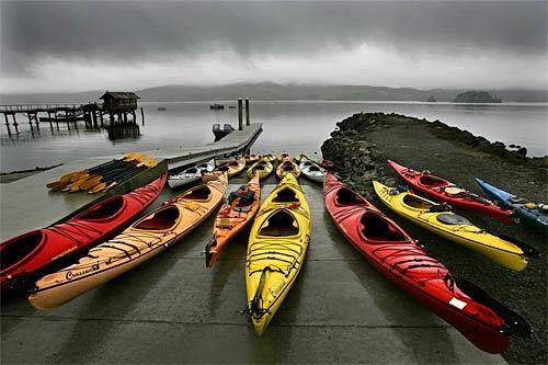A colorful array of kayaks brightens up a foggy day along Tomales Bay, the site of Nick's Cove, a cozy new complex that stretches alongside Highway 1 just north of the town of Point Reyes.