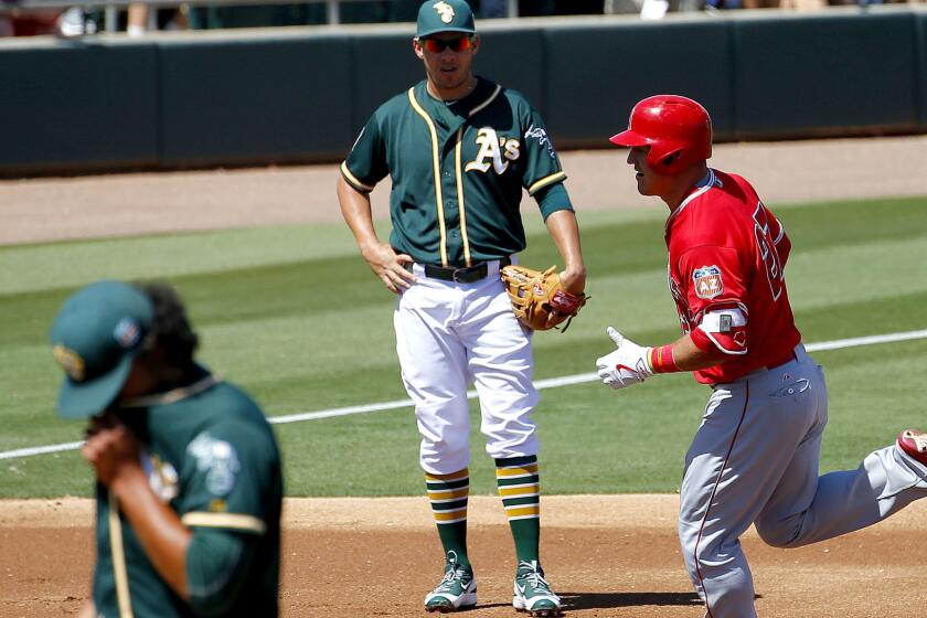 Angels center fielder Mike Trout rounds the bases after hitting a solo home run against the A's in the first inning Friday.