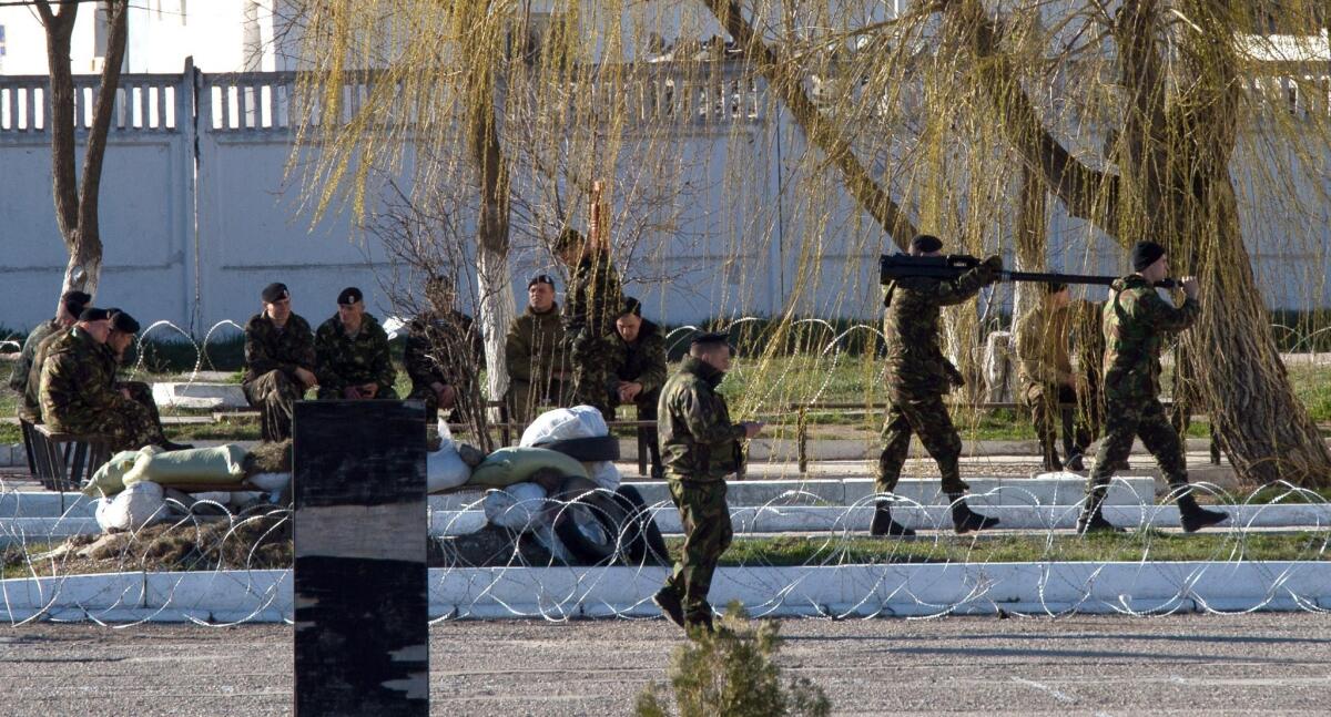 Ukrainian soldiers load weapons and amunition into trucks at a Ukrainian marine battalion in the Crimean city of Feodosia.