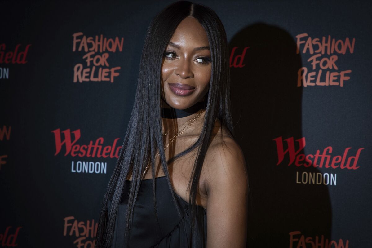 A woman posing in a black dress
