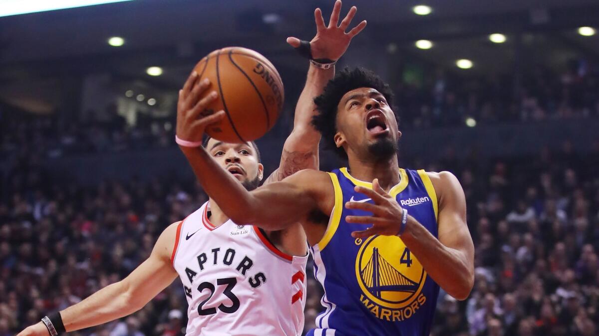 Warriors guard Quinn Cook drives past Raptors guard Fred VanVleet for a layup during Game 1 of the NBA Finals on May 30, 2019.