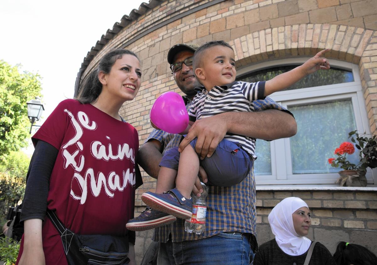 Refugees Nour Essa, husband Hasan Zaheda and son Riad are among the 12 Syrians plucked from a Greek camp by Pope Francis and placed with the charity Sant’Egidio in Rome’s Trastevere neighborhood.