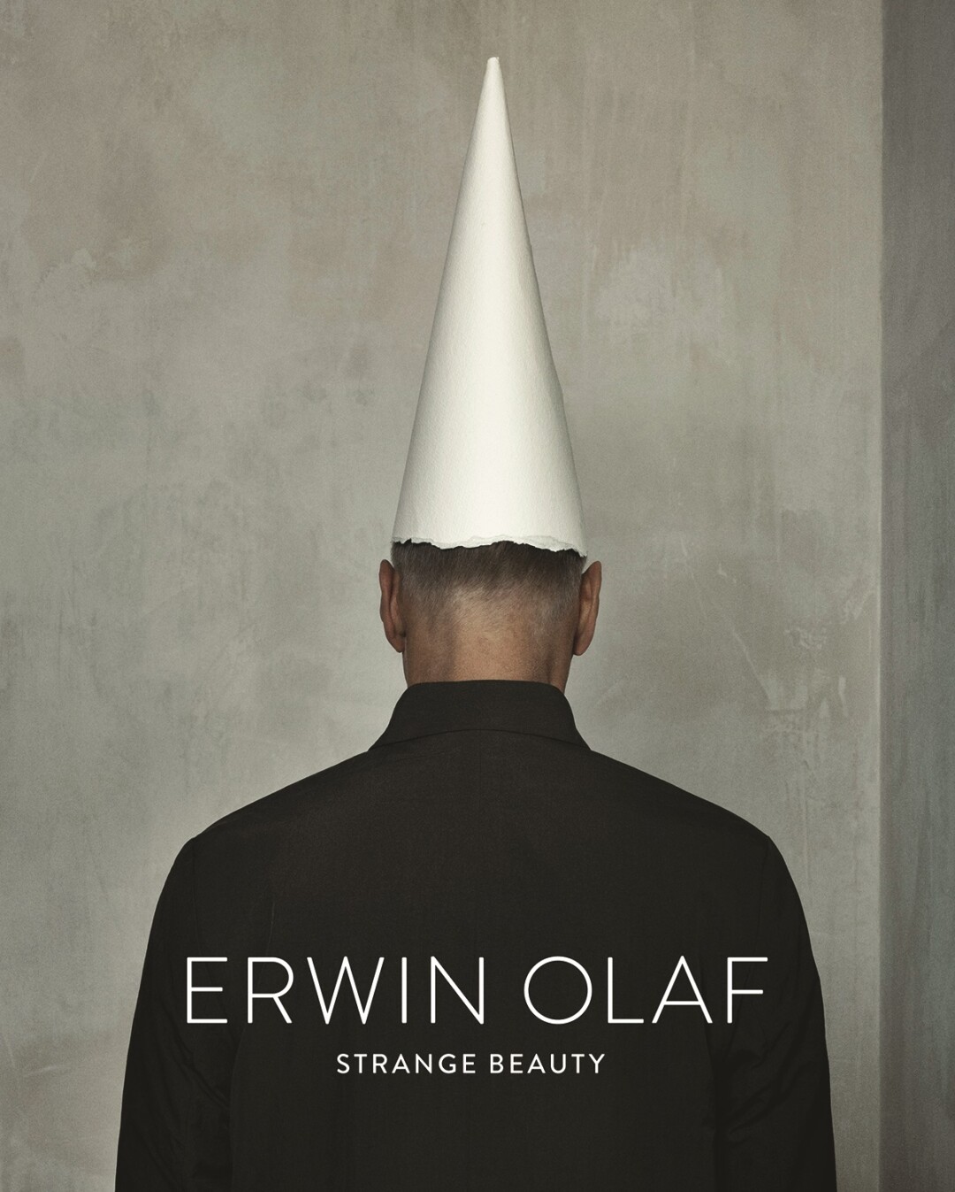 The back of a man with a white cone on his head