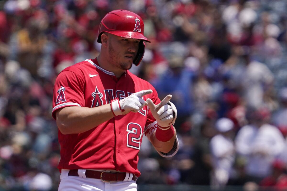 Angels star Mike Trout gestures after hitting a ground-rule double in the first inning Sunday.