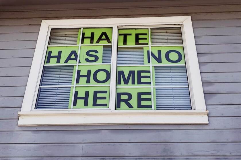 A window sign in Santee addresses a recent incident where a man wore a KKK hood into a Vons grocery store.