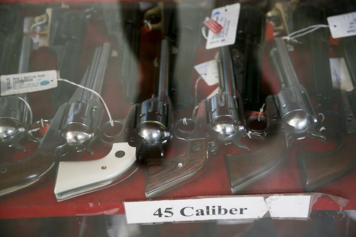 Revolvers sit in a display case at a gun store in Tulsa, Okla., on March 15, 2020.