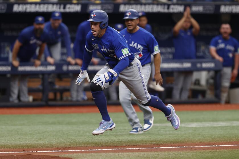 Toronto Blue Jays' George Springer dives into home plate after hitting a three-run home run against the Tampa Bay Rays during the second inning of a baseball game Sunday, Sept. 24, 2023, in St. Petersburg, Fla. (AP Photo/Scott Audette)