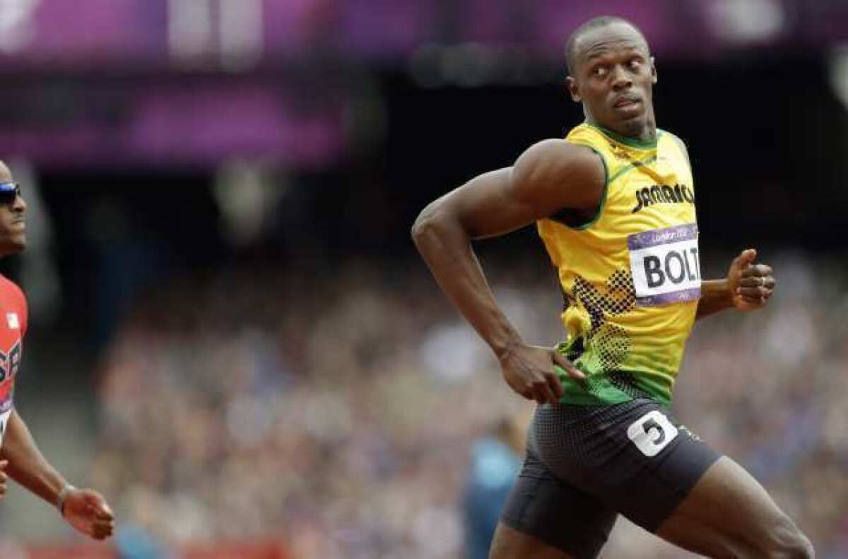 Usain Bolt competes in a men's 200-meter heat Tuesday.