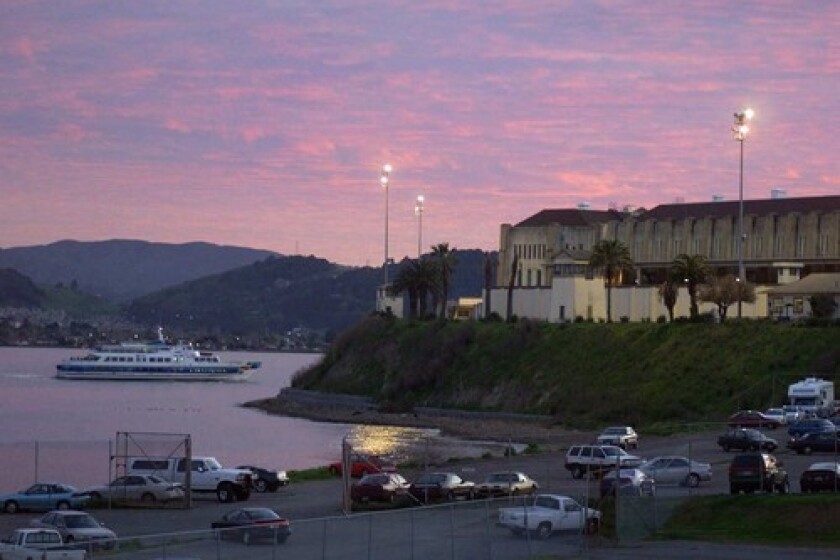 A ferry passes San Quentin State Prison, an aging 432-acre facility that sits on prime real estate overlooking San Francisco Bay.